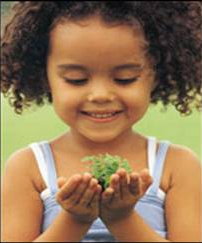 A child holding a plant.